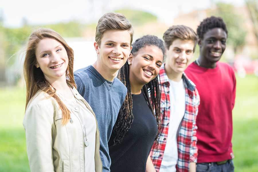 group of teens smiling outside giving you venture academy at a glance