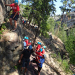 Photo Gallery: Teen Encouraging the Rest of Her Team to Join Her During Rock Climbing