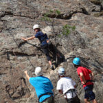 Photo Gallery: Teen Receiving Encouragement from Counselors During Rock Climbing Activity