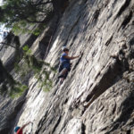 Photo Gallery: Teen Rock Climber Looking Down at Her Progress