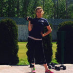 a teen girl lifts weights outside