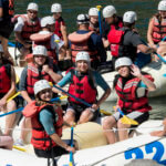 teams of teens in whitewater rafts