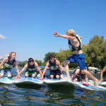 Photo Gallery: Teens Riding Boogie Boards on the Lake