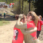 Photo Gallery: Teens Embracing After Finishing Mudd, Sweat, and Tears Event