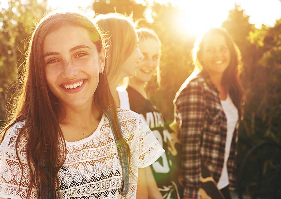 four smiling girls in nature exhibit a behaviour treatment youth profile