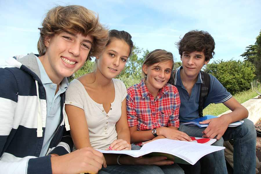 four preteens study together in the summer semester