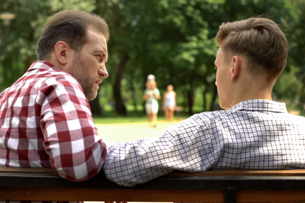 man talking to son on park bench about Teen Inhalant Abuse
