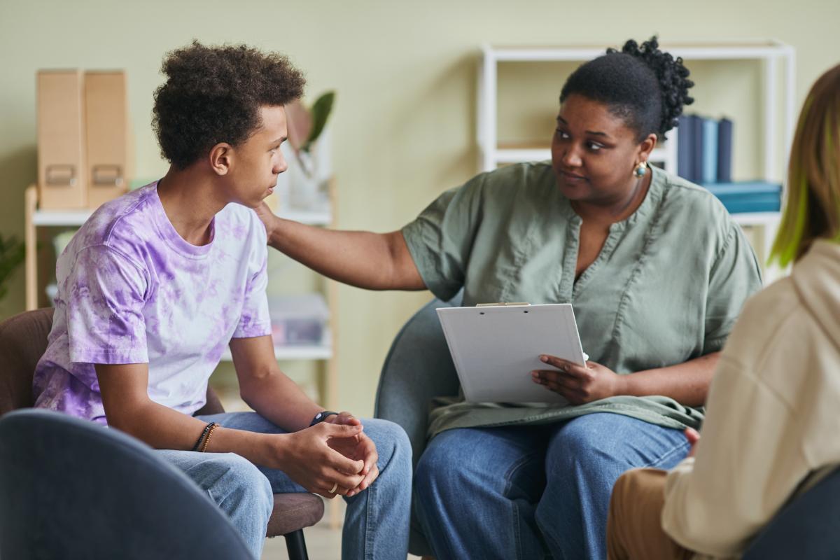 a counsellor in drug and alcohol treatment teaches teens about the negative side effects of marijuana abuse