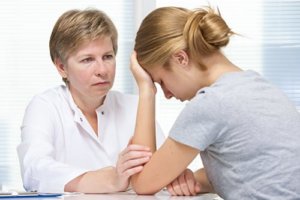 Troubled teen talking to mental health counsellor