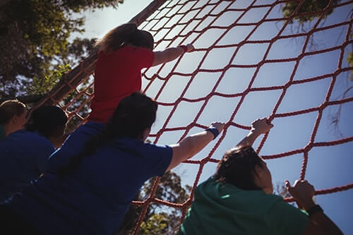 group of girls climb rope net at military school for troubled teens