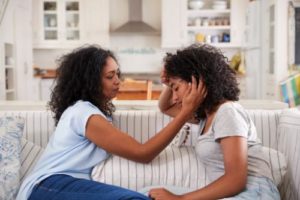 a mother helps her teen with anxiety