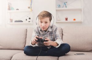 Young boy struggling with video game addiction