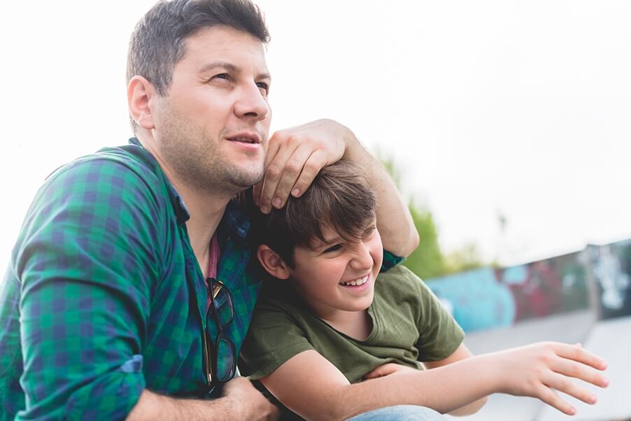 a dad plays around with his son discussing the parent newsletter