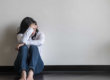 woman with her head down why it's important to know the symptoms of depression in teenagers