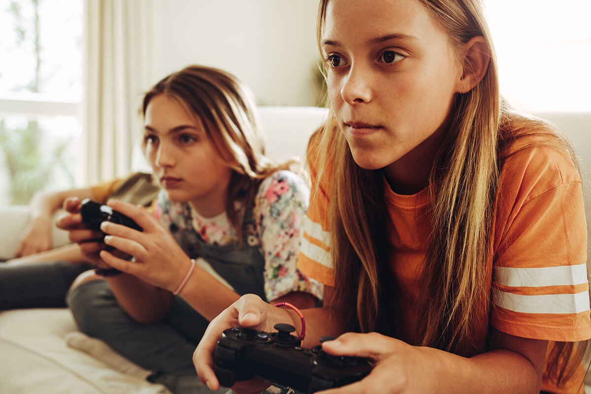 two children with game controllers showing Problematic Video Gaming Behavior