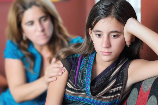 a parent helps her teen who struggles with dyslexia