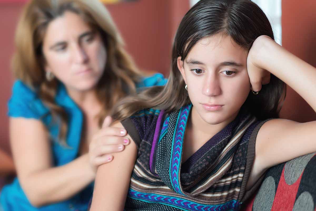 a parent helps her teen who struggles with dyslexia
