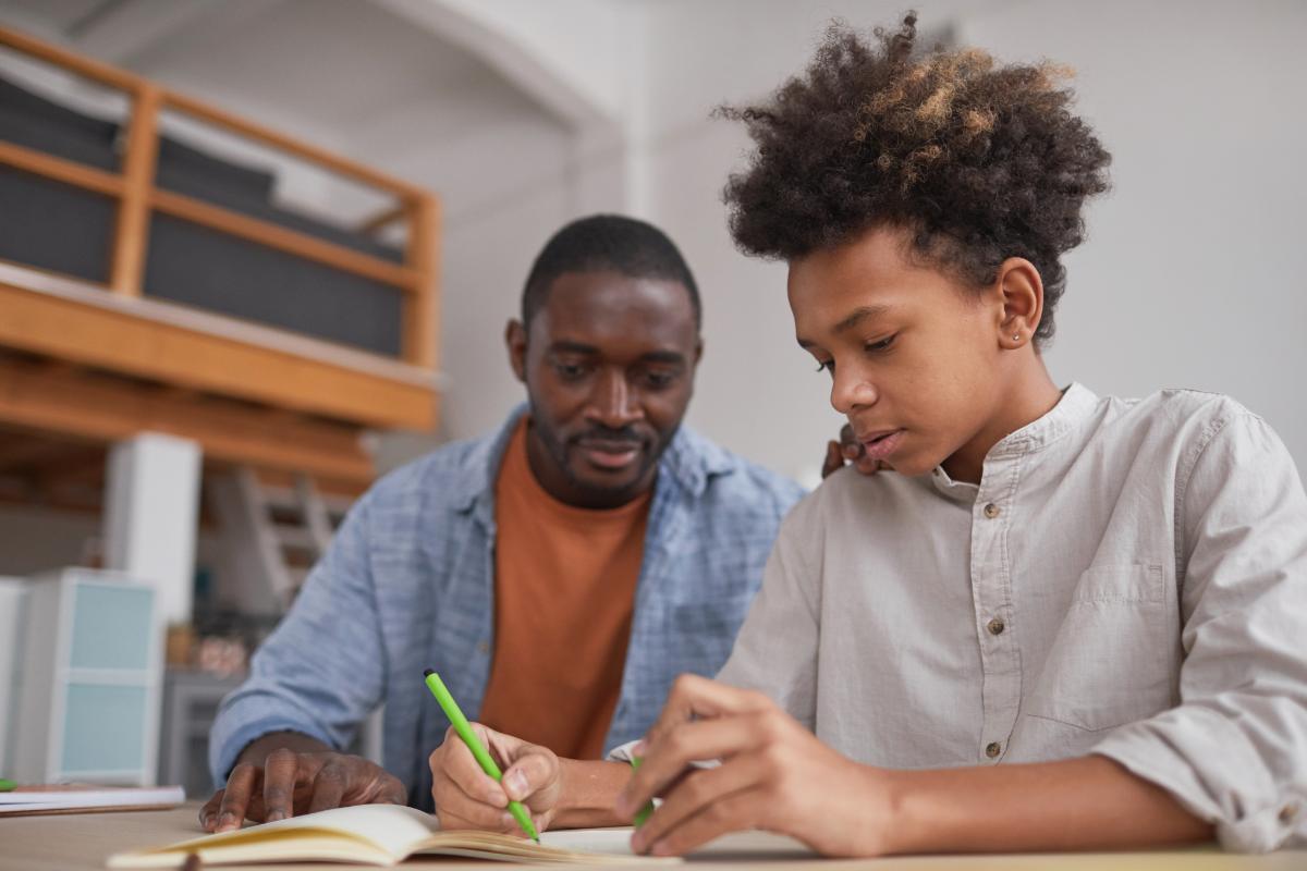 Parents are the best teachers. Looking down on a child doing homework.