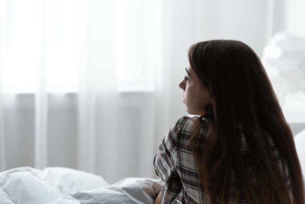 a woman expressing signs of childhood trauma