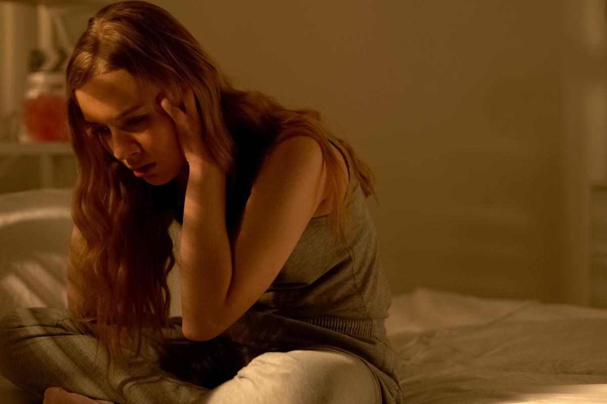 a teenager sitting on her bed suffering from anxiety in teen girls