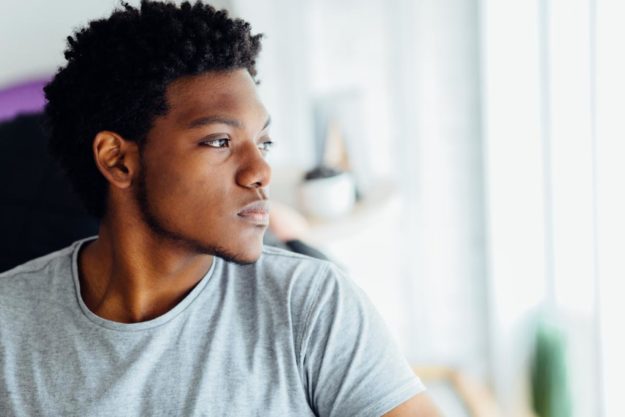 man-looking-out-window-thinking-about-vyvanse-side-effects