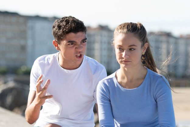 two teens are in an obviously toxic relationship as the boy screams at the girl who sits scared